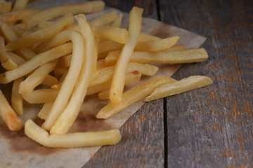 French fries on a wooden background