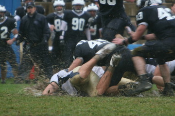Muddy Football Game Splashing All Over