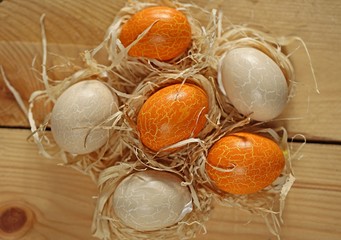 Easter. Orange and beige Easter eggs  on wooden background