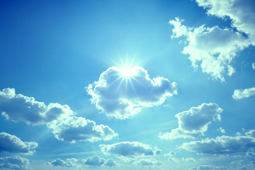Fototapeta na wymiar vivid blue barbie sky with sun star rays in unreal, fairy-tale atmosphere