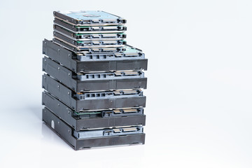 stack of old hard drives on white background