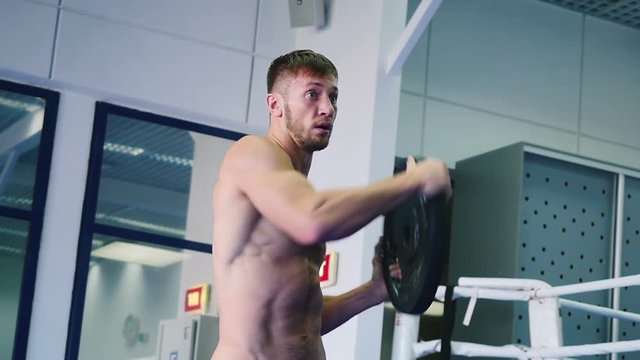 Athlete holding a dumbbell in hands.