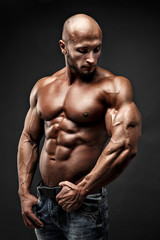 bodybuilder posing. Beautiful sporty guy male power. Fitness muscled man
