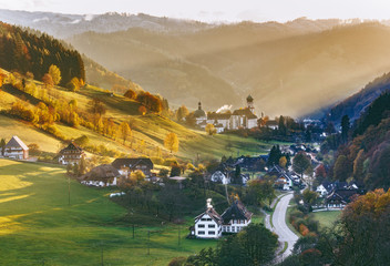 Colourful countryside landscape with mountain forests, traditional houses and old monastery. Germany, Black Forest.  - obrazy, fototapety, plakaty