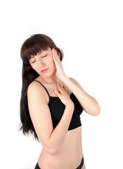 Young long-haired brunette woman in black lingerie on a white background with closed eyes touching face