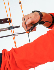 Hands of a person grabbing an archery release