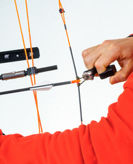 Hands of a person grabbing an archery release
