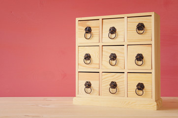 Image of natural wooden antique chest with drawers