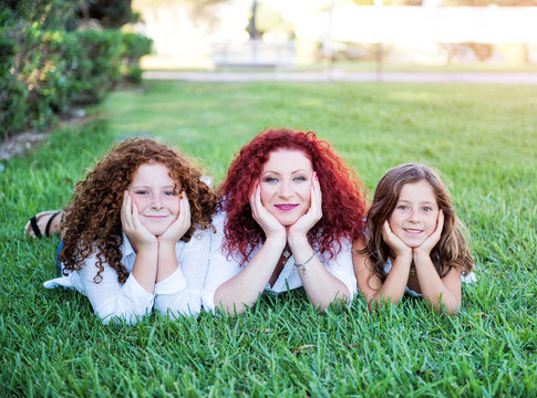 Red-haired mother and her two daughters