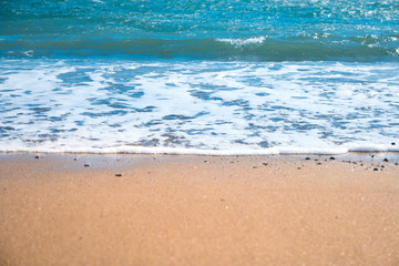 Fototapeta na wymiar Blue sea and beach with golden sand
