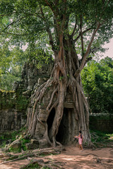 Fototapeta na wymiar A local girl walking to entrance of Ta Som Temple, Angkor, Cambodia