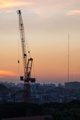 Construction crane at sunset time