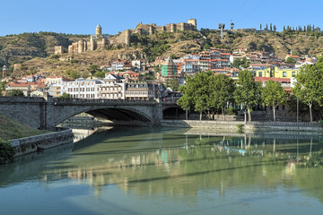 View of Narikala Fortress from the shore of Kura River near the Metekhi Bridge in Tbilisi, Georgia