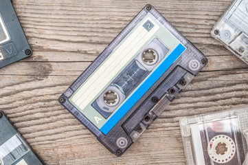 Used audio cassettes on wooden background