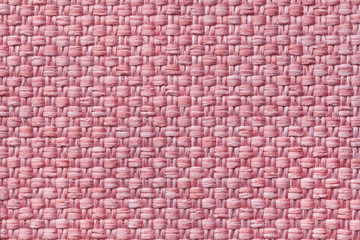 Light pink textile background with checkered pattern, closeup. Structure of the fabric macro.