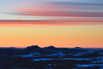 Pre-dawn sunrise over a snow covered Vedauwoo, Wyoming.  The 'turtle rock' rock formations are visible in the lower portion of the frame.  