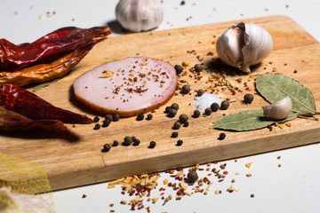 Sliced bacon and spices on the kitchen blackboard