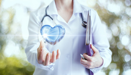 Heart in the hand of the doctor.