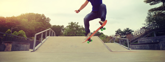 young skateboarder practice ollie trick at skatepark - obrazy, fototapety, plakaty