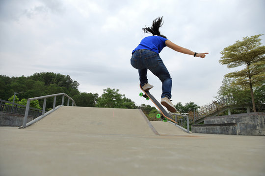 young skateboarder practice ollie trick at skatepark