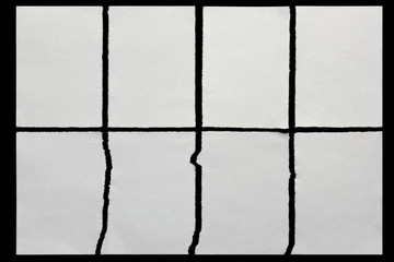 paper torn in eight pieces on a black background