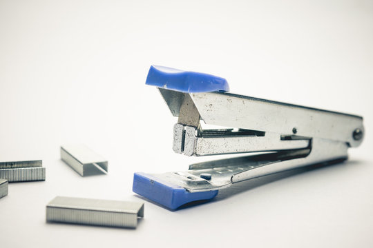 old stappler on paper with staples