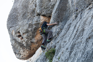 Boy climbing on a limestone wall