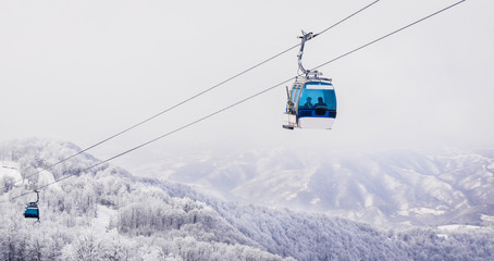 Fototapeta na wymiar Ski lift gondola mountain winter scene