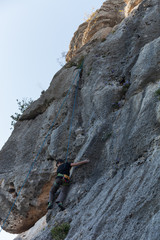 Boy climbing on a limestone wall