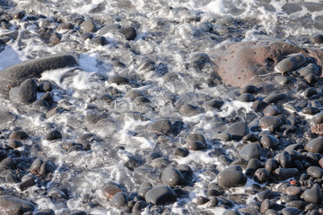 Black sand beach, ebb on volcanic stones, Tahiti 