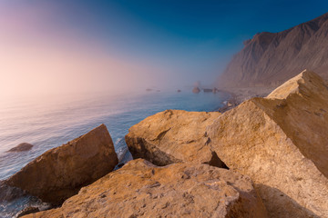 Fototapeta na wymiar Seascape with coastline at sunrise. Coastal foggy morning landscape. Crimea.