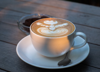 Hot coffee in a white cup on table