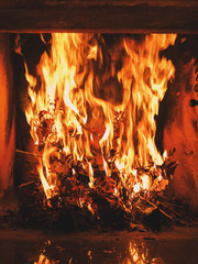Burning dried oak leaves in the fireplace. Orthodox Christianity custom during Christmas eve.