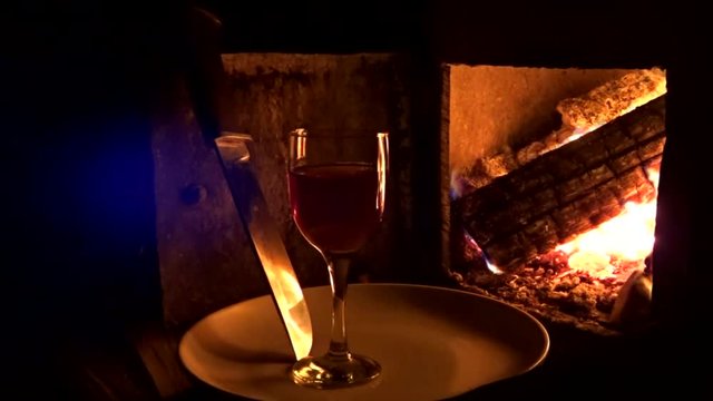 glass of wine and the flames