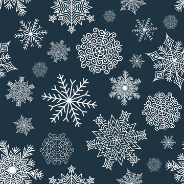 Seamless pattern of white snowflakes on a dark blue background. Included in swatches background.