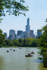 Boats in Central Park lake with skyscrapers in the background