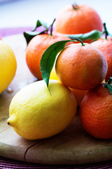 tangerines and lemons. mixed of fresh fruits with leaves.