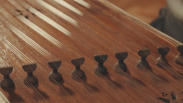 Someone is playing the ethnic musical instrument - santur