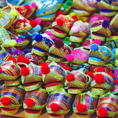 Fototapeta na wymiar Pile of Turkish traditional shoes with pompon at grand bazaar in Istanbul, Turkey.