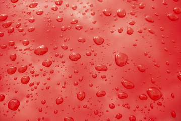 Rain drops on red background