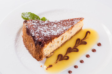 walnut cheesecake on a white plate on a light background 