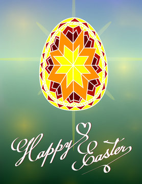 Happy Easter Card with painted egg. Hand written lettering on calligraphy style. Shine spring bokeh background. Concept for greetings card. Pysanka - decorated in traditional Ukrainian folk designs.