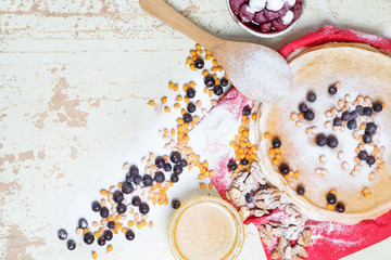 Carnival celebration, delicious pancakes close-up, with a fresh blueberry and sea buckthorn, cherries honey.