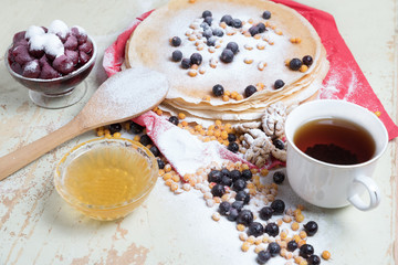 Carnival celebration, delicious pancakes close-up, with a fresh blueberry and sea buckthorn, cherries honey.
