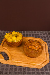Game pie served with bowl of piccalilli