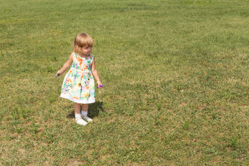 Happy baby girl playing outdoors.