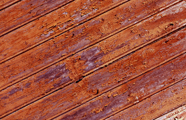 Weathered orange painted wooden wall texture.