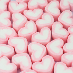 Pink heart shaped marshmallows background