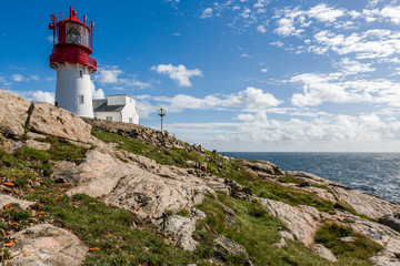 Fototapeta na wymiar Rocky coastline of Lindesnes with Lighthouse at the most souther