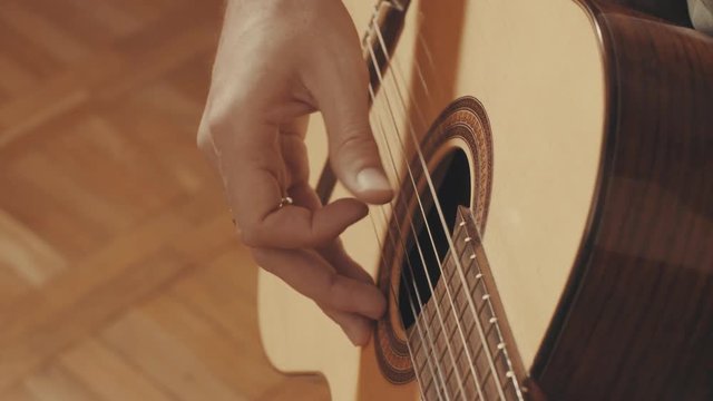 Hands of guitarist playing a guitar